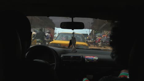 POV-view-of-people-inside-a-car,-driving-on-the-streets-of-Yaounde,-Cameroon