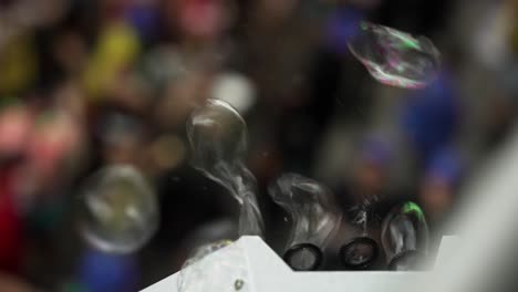 Bubble-machine-blowing-with-people-partying-on-the-background-out-of-focus