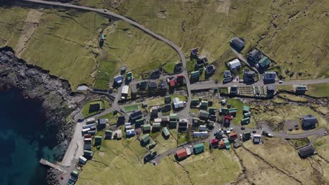 Aerial-tilt-up-shot-showing-small-village-of-Funningur-on-Eysturoy-in-Faroes-Island