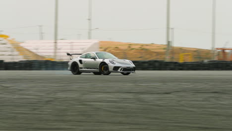 Super-car-spinning-out-and-smoking-up-the-tires-on-a-track-in-slow-motion
