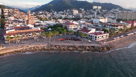 Drone-video-featuring-a-forward-flight-to-the-arches-and-outdoor-theater-at-the-Puerto-Vallarta-boardwalk,-with-a-camera-movement-that-gradually-lowers-to-end-with-a-zenithal-view-of-the-arches