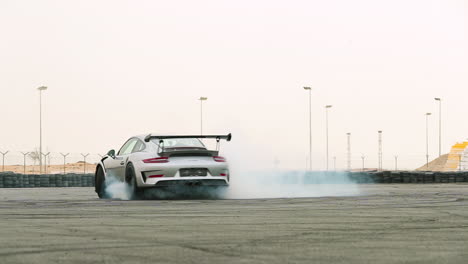 Sports-car-doing-donuts-on-a-track-in-slow-motion-with-lots-of-smoke