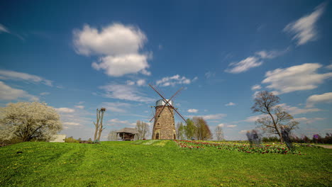 Beautiful-stone-millhouse-in-vibrant-rural-landscape,-time-lapse-view
