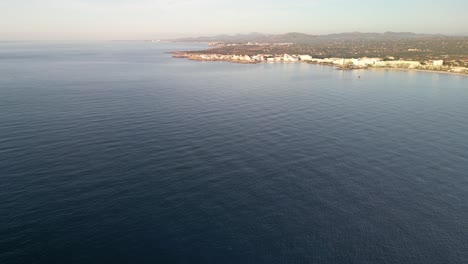 Pristine-Sea-With-Resort-Town-Near-Sa-Coma-In-Mallorca-Spain-During-Summer