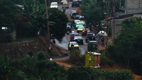Traffic-on-the-rainy-streets-of-Yaounde,-gloomy,-overcast-day-Cameroon---static-view