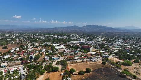 Aerial-view-around-the-Puerto-Escondido-village,-in-sunny-Oaxaca,-Mexico---circling,-drone-shot