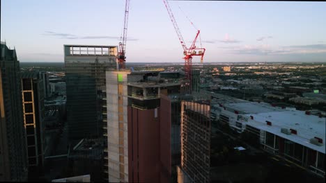 Aerial-view-around-the-1550-on-the-green-Construction-site,-sunset-in-Houston,-USA