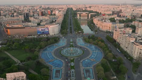 Aerial-tilt-down-shot-of-Unirii-Square-and-fountain-in-Bucharest-at-sunset
