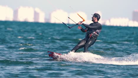 Los-Alcazares,-Spain,-May-3,-2023:-Sportsman-practicing-kite-surf-sport-at-the-beach-on-a-windy-day-at-the-Spanish-coasts