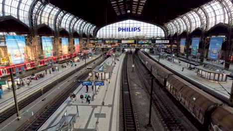 18-April-2023---Inside-View-Of-Hamburg-Hauptbahnhof-Looking-Down-At-Station-Platforms-With-Cargo-Train-Passing-Through