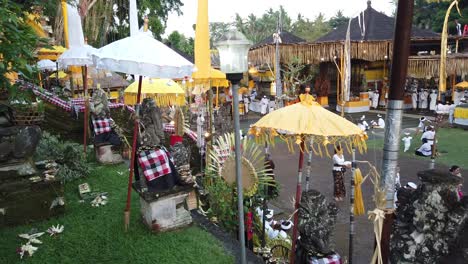 Panoramic-View-Inside-Colorful-Balinese-Temple-Ceremony-with-People-Praying-and-Enjoying-a-Religious-Festival,-in-Samuan-Tiga,-Blahbatuh,-Ancient-Landmark