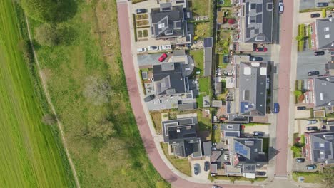 Top-down-aerial-of-a-beautiful-modern-neighborhood-with-photovoltaic-solar-panels-on-rooftops