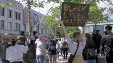 Young-woman-holds-a-Black-Lives-Matter-Sign-on-a-Protest