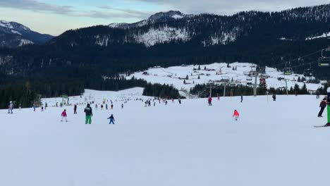 People-skiing-down-a-ski-run-in-winter-in-Bavaria,-Germany