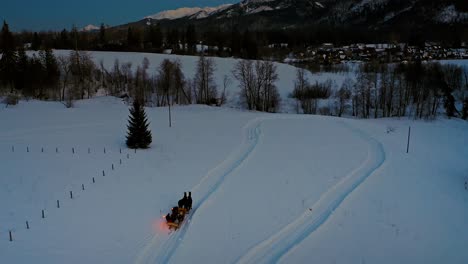 Traditional-Horse-Drawn-Sleigh-Ride---Magical-Winter-in-Poland,-drone-aerial-shot