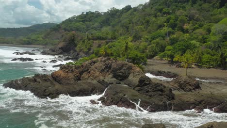 Tropical-Amancio-volcanic-rock-formation-on-wild-shore-of-Costa-Rica,-aerial