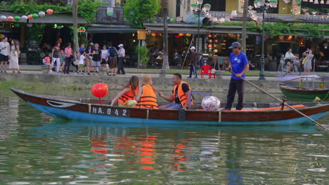 A-stationary-shot-of-tourists-onboard-a-lantern-boat-while-taking-pictures-of-each-other
