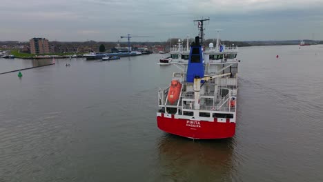 Big-Cargo-carrier-ship-navigating-through-the-canal-of-Zwijndrecht-aerial-view