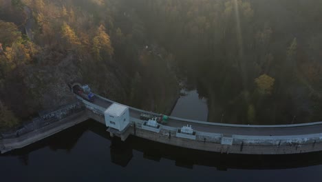Drone-shot-of-Sec-dam-in-Czech-republic-in-autumn-surrounded-by-forest