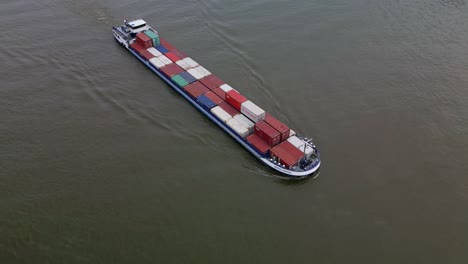 Top-down-aerial-view-of-the-Smart-Barge-container-ship-loaded-with-containers-navigating-through-the-canal