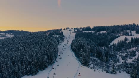 Beautiful-Drone-Aerial-Shot-of-a-skii-slope-at-sunset---Poland