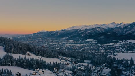 Stunning-Drone-Aerial-Shot-Over-Zakopane-in-Winter-Snow-Covered-Peaks