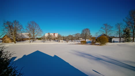 Shadow-of-house-moving-on-snowy-surface-of-northern-European-residential-landscape