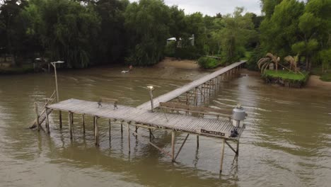 A-dynamic-aerial-shot-of-a-wooden-jetty-at-the-Parana-River-in-Argentina