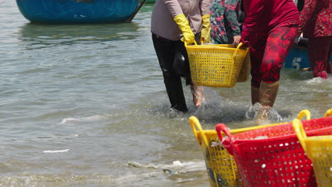 Slow-motion-of-Mui-Ne-women-offloading-fresh-catch-from-boats-in-baskets