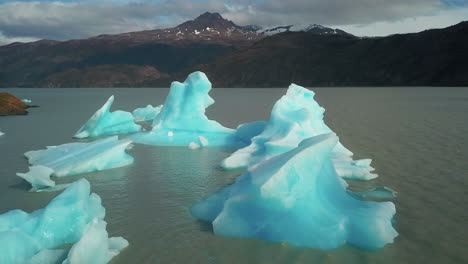 Scenic-aerial-view-flying-over-icebergs-in-the-epic-Andes-mountain-landscape-of-Patagonia,-Chile