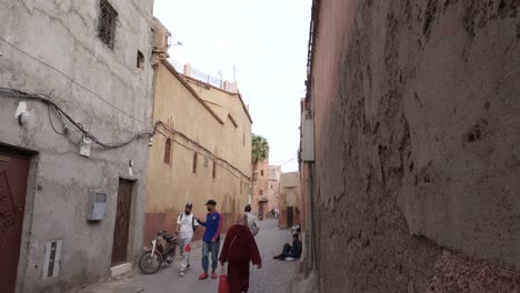 Medium-shot-of-locals-walking-on-narrow-street