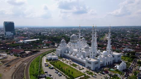 Aerial-view-of-Sheikh-Zayed-Grand-Mosque-during-day-with-cloudy-sky-on-the-background,-Surakarta,-Central-Java,-Indonesia---Aerial-white-mosque