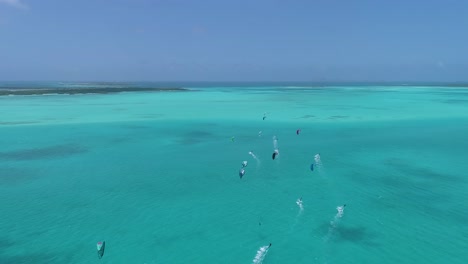 Aerial-shot-group-people-kitesurf-on-caribbean-sea-sailing-kitesafari-los-Roques