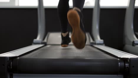 Close-Up-of-legs-man-jogging-on-treadmill-in-gym,-slow-motion