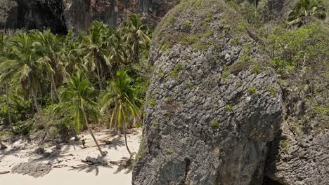Aerial-sideways-over-Playa-Fronton-beach-with-people-in-summer-season,-Samana-in-Dominican-Republic