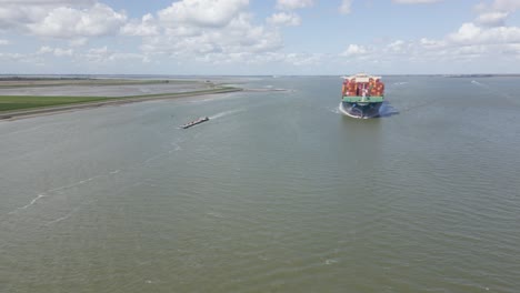 HMM-container-ship-sailing-off-Dutch-coast-on-sunny-day