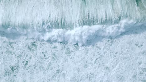 Overhead-View-Of-White-Foamy-Waves-Rolling-In-The-Coast-Of-Nazare,-Portugal