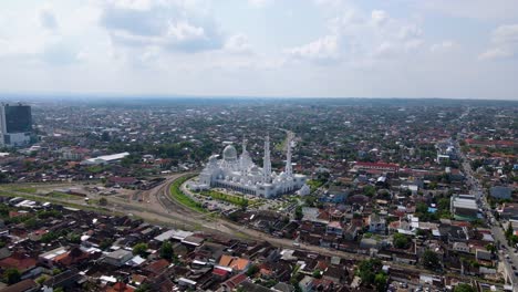Aerial-view-of-Sheikh-Zayed-Grand-Mosque-during-the-day,-Surakarta,-Central-Java,-Indonesia---Drone-shot-white-mosque