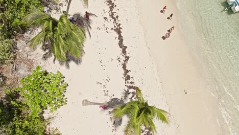 People-relaxing-on-white-tropical-and-exotic-beach-of-Playa-Fronton,-Dominican-Republic