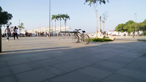 Bikes,-parked-bikes-and-people-going-back-home-at-Praca-Maua,-at-sunset,-in-the-center-of-Rio-de-Janeiro,-Brazil,-on-a-Sunday-afternoon