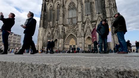Wide-shot-of-the-busy-area-around-the-Cathedral-in-Cologne-taken-from-plaza-steps