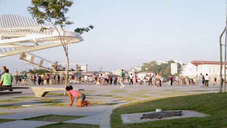 People-relaxing-at-Praca-Maua,-at-sunset,-in-the-center-of-Rio-de-Janeiro,-Brazil,-on-a-Sunday-afternoon