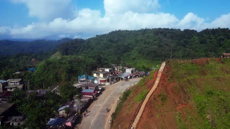 Bird's-eye-view-of-a-mountainside-village-community-with-lush,-mountainous-jungles-and-Summit-View-Park-with-a-stairway