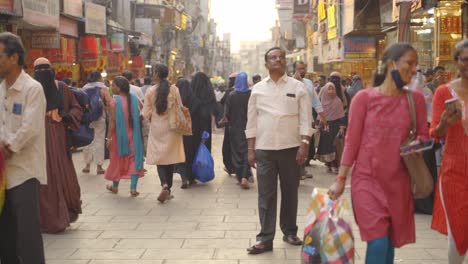 Indian-people-travelling-and-shopping-across-the-streets-of-Charminar-Jewellery-market,-slow-motion