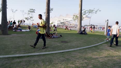 Street-seller-working-in-front-of-Museu-do-Amanha,-Tomorrow's-museum,-at-Praca-Maua,-in-Rio-de-Janeiro,-Brazil