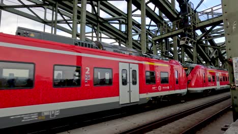 17-April-2023---Red-Regional-Express-Train-From-Deutsche-Bahn-Crossing-Hohenzollern-Bridge-In-Cologne