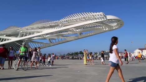 People-walking-around-Praca-Maua,-at-sunset,-in-the-center-of-Rio-de-Janeiro,-Brazil