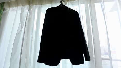 Groom's-suit-hanging-on-the-window-in-the-morning---push-in