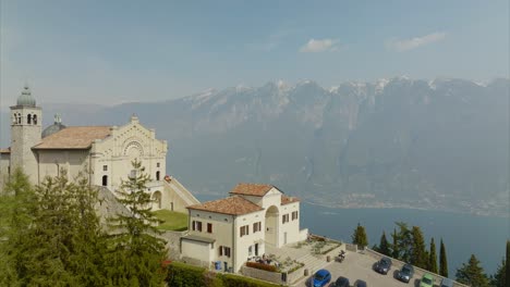 Aerial-orbiting-over-Tignale-Montecastello-shrine-on-Lake-Garda-in-Lombardy,-Italy