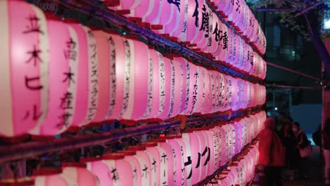 Sakura-Festival-Lanterns-in-Shibuya,-Close-Pan-Reveal-Shot